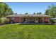 Spacious backyard featuring a covered patio and mature landscaping at 10247 W Arkansas Ave, Lakewood, CO 80232