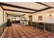 Finished basement with a bar area, wood beams, and carpeting at 10247 W Arkansas Ave, Lakewood, CO 80232