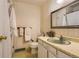 Bathroom showcasing a vintage vanity, patterned wallpaper, and a decorative mirror and accents at 10247 W Arkansas Ave, Lakewood, CO 80232