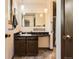 Bathroom featuring modern vanity, stylish lighting, and walk-in shower with grab bars at 10247 W Arkansas Ave, Lakewood, CO 80232