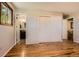 Bright bedroom featuring hardwood floors, ensuite bath, and a closet for storage at 10247 W Arkansas Ave, Lakewood, CO 80232