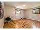 Sun-filled bedroom boasts gleaming hardwood floors and natural light from two large windows at 10247 W Arkansas Ave, Lakewood, CO 80232