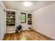 Bedroom features built-in shelving and hardwood floors, providing ample storage space at 10247 W Arkansas Ave, Lakewood, CO 80232