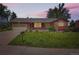 Charming single-Gathering home with mature landscaping, a large front lawn and an attached two-car garage at 10247 W Arkansas Ave, Lakewood, CO 80232