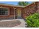 Inviting front porch with brick accents, walkway, and decorative wreath, creating a warm welcome at 10247 W Arkansas Ave, Lakewood, CO 80232