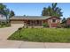 Charming single-story home featuring a well-manicured lawn and a classic brick and wood facade at 10247 W Arkansas Ave, Lakewood, CO 80232