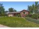 Charming front yard with brick accents and mature trees at 10247 W Arkansas Ave, Lakewood, CO 80232