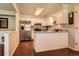 Well-lit kitchen with stainless steel appliances, granite countertops, and white cabinetry at 10247 W Arkansas Ave, Lakewood, CO 80232