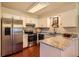 Modern kitchen featuring stainless steel appliances, granite countertops, and ample cabinet space at 10247 W Arkansas Ave, Lakewood, CO 80232