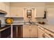Functional kitchen with stainless steel dishwasher, granite countertops, and sleek white cabinets at 10247 W Arkansas Ave, Lakewood, CO 80232