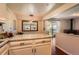Bright kitchen with granite countertops, white cabinets and a view to the outdoor living space at 10247 W Arkansas Ave, Lakewood, CO 80232