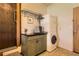 A well-organized laundry room with modern washer/dryer and storage cabinets at 10247 W Arkansas Ave, Lakewood, CO 80232