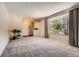 Spacious living room with large window, plush carpet, and neutral tones perfect for relaxation at 10247 W Arkansas Ave, Lakewood, CO 80232