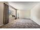 Bright living room with big window, carpeted flooring, neutral wall color and natural light at 10247 W Arkansas Ave, Lakewood, CO 80232