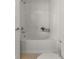 Bathroom featuring a white tiled shower and a soaker tub at 15612 E 96Th Way # 9B, Commerce City, CO 80022