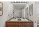 Bathroom with double vanity sinks, bright lighting and large mirror at 15612 E 96Th Way # 9B, Commerce City, CO 80022