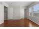 Bedroom with wood floors, a closet, and a large window providing natural light at 15612 E 96Th Way # 9B, Commerce City, CO 80022