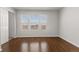 This bedroom boasts gleaming hardwood floors and multiple windows allowing abundant natural light at 15612 E 96Th Way # 9B, Commerce City, CO 80022