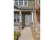 Close-up of the front door entrance with stone and post detail adding an elegant touch at 15612 E 96Th Way # 9B, Commerce City, CO 80022