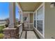 Inviting front porch with stone base posts and classic white railing, providing a cozy outdoor space at 15612 E 96Th Way # 9B, Commerce City, CO 80022
