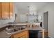 Efficient kitchen with stainless steel appliances, bar counter, and open layout enhances a comfortable space at 15612 E 96Th Way # 9B, Commerce City, CO 80022