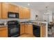 Kitchen features wood cabinets, appliances, and bar top, great for meal prep and conversation at 15612 E 96Th Way # 9B, Commerce City, CO 80022