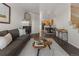 Open-concept living room with hardwood floors, fireplace, and staircase leading to the upper level at 15612 E 96Th Way # 9B, Commerce City, CO 80022