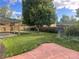The backyard features a large tree, grass and a covered patio, perfect for outdoor relaxation at 2617 S Cimarron St, Aurora, CO 80014
