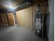 Basement utility room with water heater and access to other parts of the basement at 2617 S Cimarron St, Aurora, CO 80014
