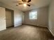 Neutral bedroom with window, ceiling fan, and closet with sliding door at 2617 S Cimarron St, Aurora, CO 80014