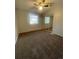 A carpeted bedroom featuring a window with blinds and mirrored closet doors at 2617 S Cimarron St, Aurora, CO 80014