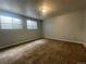 A light-filled bedroom with dual windows and new carpet at 2617 S Cimarron St, Aurora, CO 80014