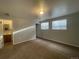 Bedroom with natural light, new carpeting, and a doorway into an en-suite bathroom at 2617 S Cimarron St, Aurora, CO 80014