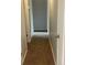 Hallway with carpet and gray walls leading to rooms with white doors and trim at 2617 S Cimarron St, Aurora, CO 80014