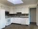 A full view of the kitchen with white cabinets, appliances, gray counter tops, and brown tile backsplash at 2617 S Cimarron St, Aurora, CO 80014