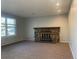 Spacious living room with neutral carpet and a stone fireplace at 2617 S Cimarron St, Aurora, CO 80014