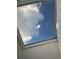 A view looking up at a skylight, capturing white fluffy clouds and a blue sky at 2617 S Cimarron St, Aurora, CO 80014