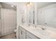 Bright bathroom featuring a double vanity and shower with curtain at 7415 E 158Th Pl, Thornton, CO 80602
