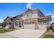 Two-story home with stone accents, a two-car garage, and a well-kept lawn at 7415 E 158Th Pl, Thornton, CO 80602
