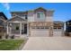 Charming two-story home featuring a three car garage and a welcoming front porch at 7415 E 158Th Pl, Thornton, CO 80602