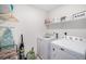 Well-organized laundry room with washer, dryer, and storage shelves at 7415 E 158Th Pl, Thornton, CO 80602