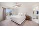 Calming main bedroom has a ceiling fan, a window with natural light, and an en-suite bathroom at 7415 E 158Th Pl, Thornton, CO 80602