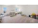 Spacious playroom offers abundant natural light, storage shelves, and space for creative play at 7415 E 158Th Pl, Thornton, CO 80602