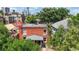 Aerial view of a brick home surrounded by lush greenery, showing the rooftop and neighboring buildings at 2227 N Ogden St, Denver, CO 80205