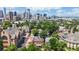Aerial view showcasing the Denver skyline and surrounding neighborhood with mature trees at 2227 N Ogden St, Denver, CO 80205
