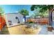 Fenced backyard with a grill, wood deck, small outbuilding, and mature trees at 2227 N Ogden St, Denver, CO 80205