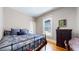 Cozy bedroom features hardwood floors, a vintage cabinet and stylish decor at 2227 N Ogden St, Denver, CO 80205