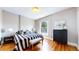 Comfortable bedroom with natural light, hardwood floors, and stylish furnishings at 2227 N Ogden St, Denver, CO 80205