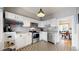 Modern kitchen with white cabinets, stainless steel appliances, patterned floors, and open access to other rooms at 2227 N Ogden St, Denver, CO 80205