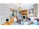 Cozy living room with hardwood floors, a decorative fireplace, vintage lighting and a stylish area rug at 2227 N Ogden St, Denver, CO 80205